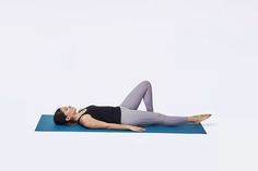 a woman laying on a yoga mat in the middle of her body with one leg up