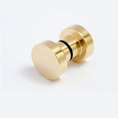 two brass knobs on white background