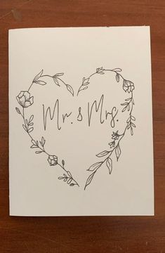 a heart shaped card with the word mr and mrs written in black ink on it