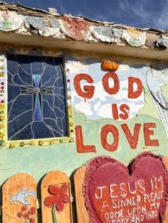 a painted wall with hearts and words on it that say god is love, jesus i'm a sinner place