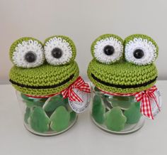 two crocheted green frogs in a jar with candy