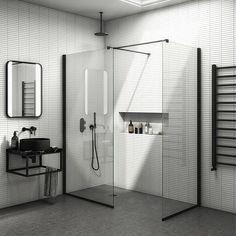 a black and white photo of a bathroom with shower, sink, mirror and towel rack