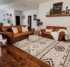 a living room with two couches and a rug