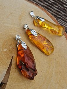 Welcome to handmade Baltic Amber jewelry shop. This Item is made of genuine, natural Amber. This item will make You look simple but gorgeous. Yellow or brown raw pendant. Shiny and elegant natural Baltic Amber pendant. Small gemstone cabochon.  Length: ~ 5 cm  Our handmade jewelry is made with passion and love. If you have any problems with your order please contact us. Please note that colors can vary from originals depending on computer monitor's settings. Due to amber is being unique and natural gemstone, each item may be slightly different in shades or shapes. Items may have natural imperfections like lines and spots, specks, coloration and inclusions, layers and lines .  All amber is fossilized tree resin and it is extremely light gemstone. Baltic amber has healing properties because Cheap Amber Jewelry Gift, Luxury Amber Jewelry With Accent Stones, Luxury Handmade Baltic Amber Necklace, Luxury Large Stone Amber Jewelry, Luxury Handmade Amber Gemstones, Cheap Amber Necklaces For Gifts, Amber Stone Jewelry, Luxury Amber Natural Stone Beads, Luxury Baltic Amber Pendant Necklace