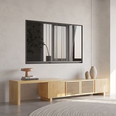 a living room with a large mirror on the wall next to a table and vase