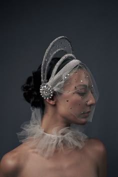 a woman wearing a veil and head piece