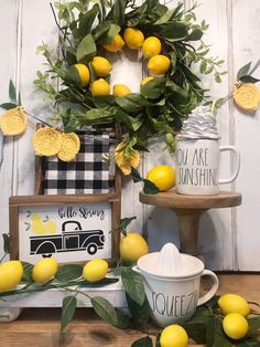 lemons and greenery are displayed on display in front of a wall mounted sign