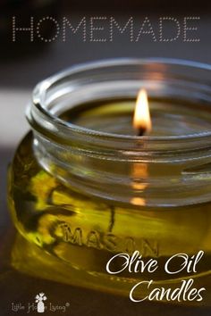 a mason jar filled with oil and a lit candle