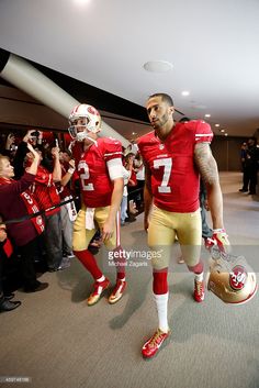 two football players are walking through the tunnel