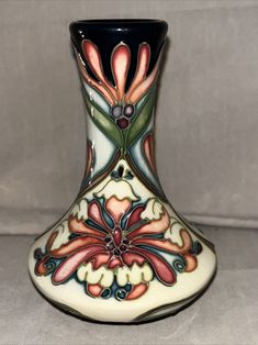 There are a few glaze cracks on the piece, but otherwise in very good condition and very beautiful This vintage Moorcraft by Rachel Bishop Florian Dream vase is a beautiful addition to any collection. The small size, measuring 4-3/8 inches in height and 3-1/4 inches in width, makes it a perfect decoration for any room. The vase features a multicolor floral pattern that is sure to catch anyone's eye. This original piece was manufactured in 2004 and is signed by the artist. The vase has a dreamy subject and an art deco style that adds a touch of elegance to any space. Whether you're a collector or just looking for a unique decoration, this Moorcraft vase is a must-have. Please check out my other listings, as I try to list items daily. Add me as a seller so you don’t miss out on any new items Art Nouveau Vase, Art Movements, Unique Decoration, Art Movement, Art Deco Style, Deco Style, Art Deco Fashion, Unique Decor, New Items