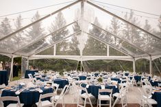 a large tent with tables and chairs set up for an event