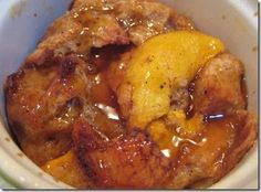 a close up of food in a bowl with sauce on the top and fruit inside