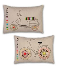 two decorative pillows with bicycles on them