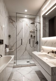 a bathroom with marble walls and flooring is shown in this image, there are two sinks on either side of the bathtub