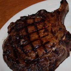 a piece of steak on a white plate