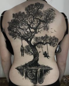 the back of a woman's body with a tree and two people on swings