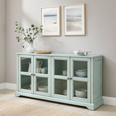 a blue cabinet with glass doors and plates on it