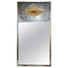 a mirror with a gold flower on it