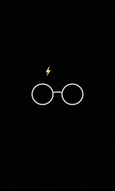 an image of harry potter's glasses with a lightning bolt in the dark sky