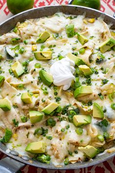 a skillet filled with chicken, avocado and cheese