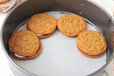 four cookies sitting on top of a metal pan