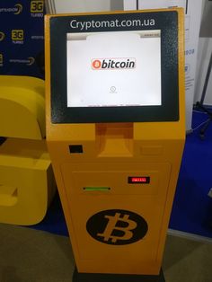 a bitcoin machine sitting in front of a sign