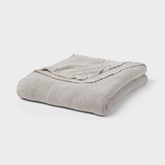 a blanket folded on top of a white surface