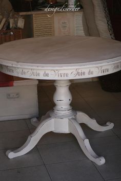 a white table sitting on top of a tiled floor