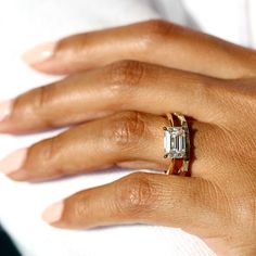 a woman's hand with an engagement ring on it