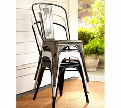 a metal chair sitting on top of a brown rug next to a white house door