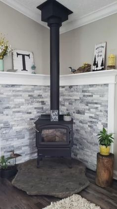 a living room with a wood stove and white brick wall in the corner, surrounded by potted plants