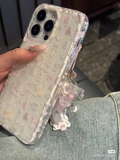 someone is holding their phone case with some little animals on the front and back sides