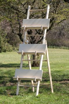 a set of three wooden steps sitting in the grass