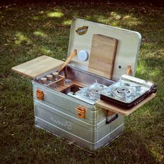 an old fashioned stove is set up in the grass to cook food on it's burners