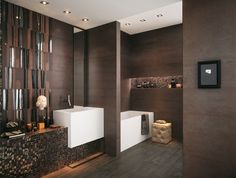 a modern bathroom with two sinks and tiled walls