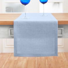 two wine glasses sitting on top of a table