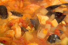 a bowl filled with soup and vegetables on top of a table