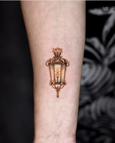 a small tattoo on the arm of a person with a light bulb attached to it