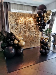 black and gold balloons are on the floor in front of a wall with an art party sign