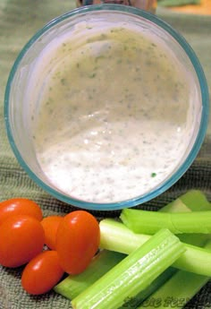 some vegetables and dip in a bowl on a table