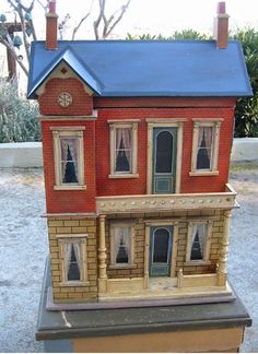 a doll house on top of a small table