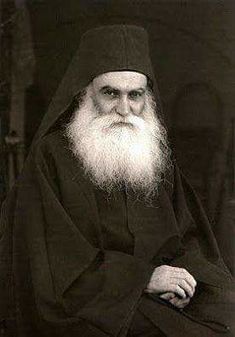 an old black and white photo of a man with a long beard wearing a robe