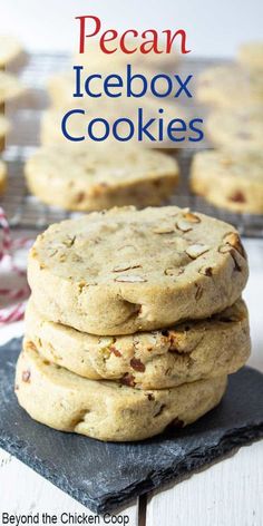 a stack of pecan icebox cookies sitting on top of a black slate plate