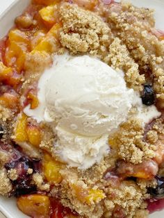 a white bowl filled with fruit and ice cream