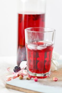 two glasses filled with liquid sitting on top of a table