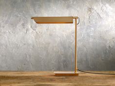 a desk lamp sitting on top of a wooden table