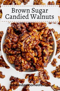 brown sugar candied walnuts in a white bowl on top of a white table