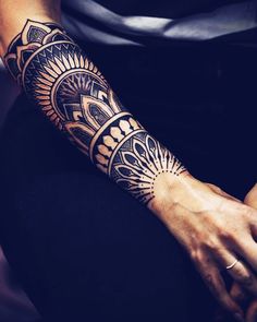 a woman's arm with a tattoo on it that has an intricate design in the middle