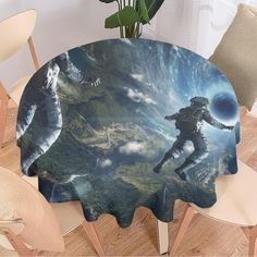 a table topped with a painting of two people flying through the air on top of clouds