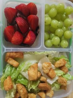 two plastic containers filled with salad and fruit